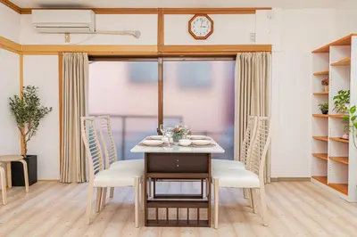 a dining room with a table and chairs at Mori House \u8d64\u7fbd\u4e00\u6237\u5efa in Tokyo