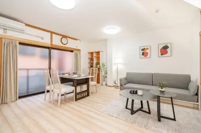a living room with a couch and a table at Mori House \u8d64\u7fbd\u4e00\u6237\u5efa in Tokyo