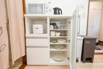 a kitchen with a pantry with white cabinets at Mori House \u8d64\u7fbd\u4e00\u6237\u5efa in Tokyo