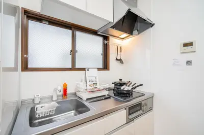 a small kitchen with a sink and a stove at Mori House \u8d64\u7fbd\u4e00\u6237\u5efa in Tokyo