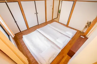 a small room with a white bed in a room at Mori House \u8d64\u7fbd\u4e00\u6237\u5efa in Tokyo