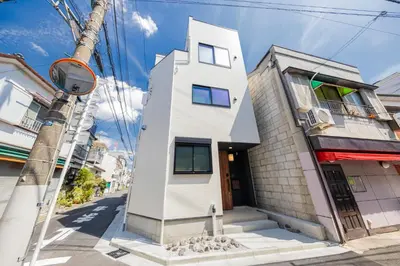 a white house on a city street at \u4eac\u6708Kyogetsu in Tokyo