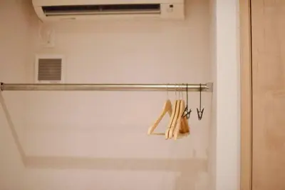 a closet with a towel rack with shoes on it at Komorebi Rill \u6d45\u8349 in Tokyo
