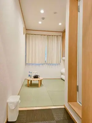 a room with a table in front of a window at Komorebi Rill \u6d45\u8349 in Tokyo