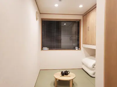 a small table in a room with a window at Komorebi Rill \u6d45\u8349 in Tokyo