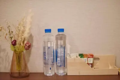 two bottles of water are sitting on a table at Komorebi Rill \u6d45\u8349 in Tokyo