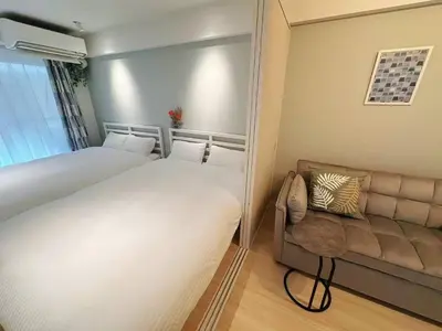 a small bedroom with a bed and a couch at Louis House\u5927\u585a\u897f \u6c60\u888b2\u5206 in Tokyo