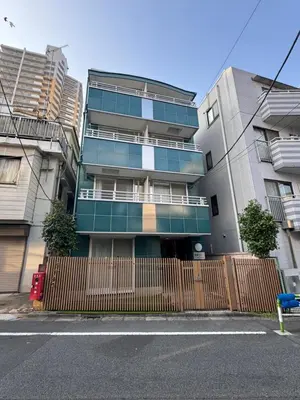 an apartment building with a fence in front of it at Louis House\u5927\u585a\u897f \u6c60\u888b2\u5206 in Tokyo