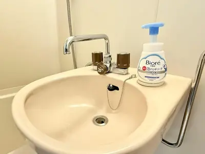 a white sink with a bottle of detergent on it at \u6c60\u888b Energy CA0 a9 in Tokyo