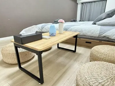 a bedroom with a bed and a table and a bed at Ikebukuro IVY House Ao6 in Tokyo