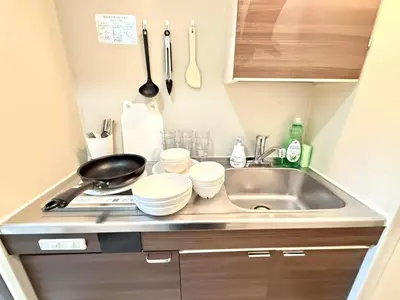 a small kitchen with a sink and a stove at Ikebukuro IVY House Ao6 in Tokyo