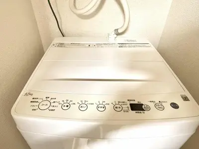 a white toilet in a bathroom with the lid down at Ikebukuro Warm\u30cf\u30a6\u30b9306 in Tokyo