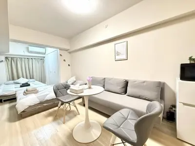 a living room with a couch and a table at Ikebukuro Warm\u30cf\u30a6\u30b9306 in Tokyo