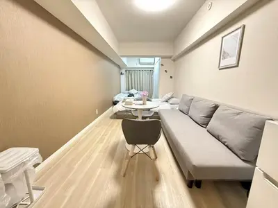 a living room with a couch and a table at Ikebukuro Warm\u30cf\u30a6\u30b9306 in Tokyo