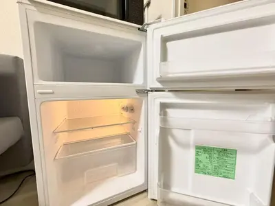 an empty refrigerator with its door open in a kitchen at Ikebukuro Warm\u30cf\u30a6\u30b9306 in Tokyo