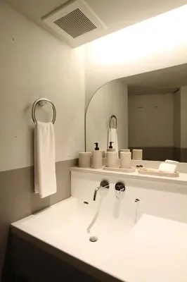 a bathroom with a sink and a mirror at New Open 