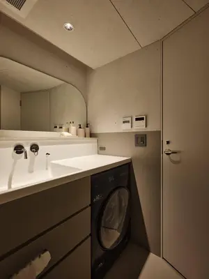 a bathroom with a sink and a washing machine at New Open 