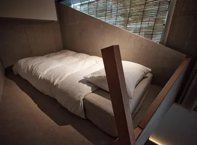 a small bed in a room with a window at New Open 
