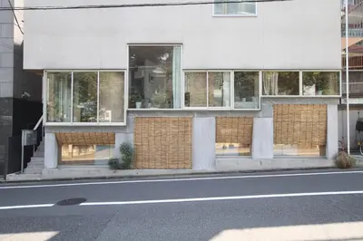 a building with windows on the side of a street at New Open 