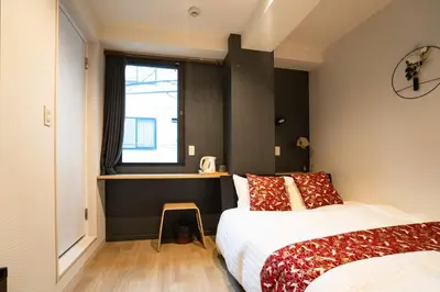 a bedroom with two beds and a window at Tokyo Biyori Hotel - Vacation STAY 07393v in Tokyo