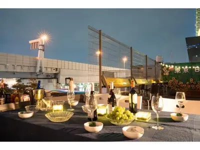 a table with wine glasses and grapes on a rooftop at Tokyo Biyori Hotel - Vacation STAY 07393v in Tokyo