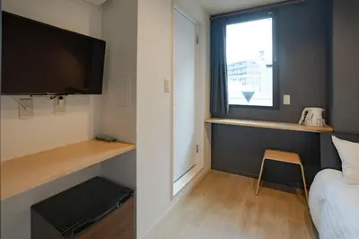 a small room with a bed and a window at Tokyo Biyori Hotel - Vacation STAY 07393v in Tokyo
