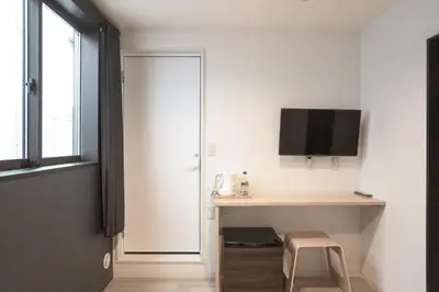 a room with a desk and a tv on a wall at Tokyo Biyori Hotel - Vacation STAY 07393v in Tokyo