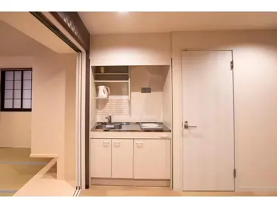 a kitchen with white cabinets and a sink at Tokyo Biyori Hotel - Vacation STAY 07403v in Tokyo
