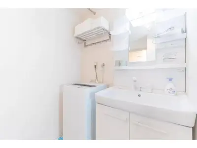 a white bathroom with a sink and a mirror at Tokyo Biyori Hotel - Vacation STAY 07403v in Tokyo