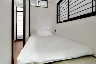 a bedroom with a large white bed with a window at 215 Building - Vacation STAY 19955 in Tokyo