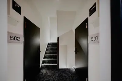 a hallway with doors and stairs in a building at 215 Building - Vacation STAY 19955 in Tokyo