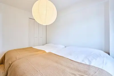 a bedroom with a bed and a light fixture at HouseHotel\u897f\u6c60\u888b in Tokyo