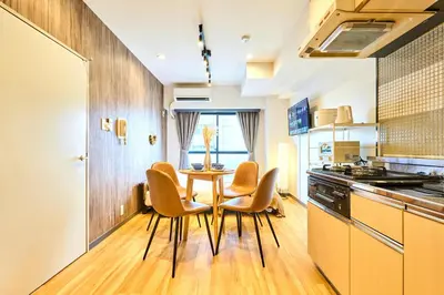 a kitchen with a table and chairs in a room at HouseHotel\u897f\u6c60\u888b in Tokyo
