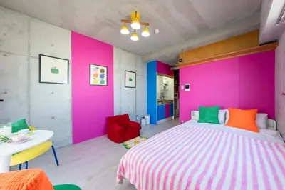 a bedroom with a large bed with colorful walls at Stayloop\u30b9\u30ab\u30a4\u30c4\u30ea\u30fc in Tokyo