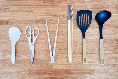 a group of utensils sitting on top of a wooden table at Unite Stay Gyotoku in Tokyo