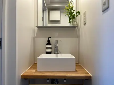 a bathroom with a white sink on a wooden table at Asakusa Loft in Tokyo