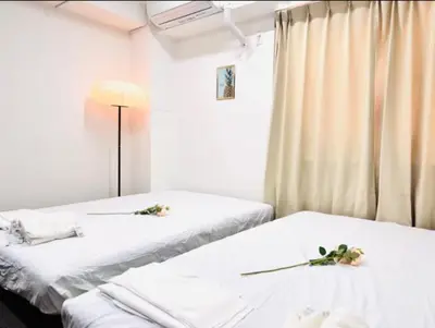 two beds in a hospital room with flowers on them at \u6751\u4e0a\u7fa9\u7537\u30c7\u30b6\u30a4\u30f3 \u6771\u4eac\u90fd\u5fc3 \u5b8c\u5168\u8cb8\u5207 \u6620\u753b\u5ba4 \u6c60\u888b\u96fb\u8eca6\u5206 \u65b0\u5bbf\u6e0b\u8c37\u76f4\u901a \u30b7\u30e7\u30c3\u30d4\u30f3\u30b0\u306b\u4fbf\u5229 WiFi \u9577\u671fOK WAGAMAMA\u5c0f\u7af9\u5411\u539fTAKA 102\u5ba4 in Tokyo