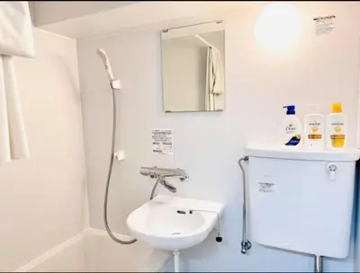 a white bathroom with a sink and a shower at \u6771\u4eac\u90fd\u5fc3\u5b8c\u5168\u8cb8\u5207 \u6620\u753b\u5ba4\u6c60\u888b\u96fb\u8eca6\u5206\u65b0\u5bbf\u6e0b\u8c37\u76f4\u901aWiFI \u9577\u671fOK WAGAMAMA\u5c0f\u7af9\u5411\u539fFUJI 101\u5ba4 in Tokyo