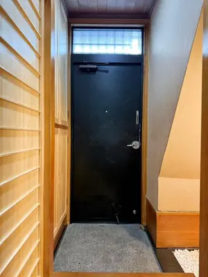 a black door with a window in a room at \u7af9\u5185\u30d3\u30eb301 in Tokyo