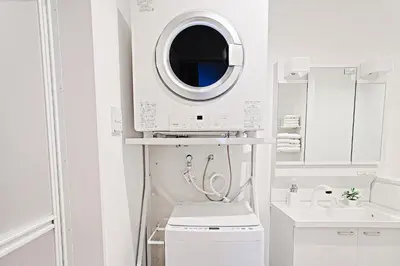 a white bathroom with a washing machine and a sink at Tomo House Yotsuya-Sanchome 201 - from 6 minutes station \u56db\u8c37\u4e09\u4e01\u76ee 201 \u99c5\u304b\u3089\u5f92\u6b696\u5206 in Tokyo