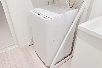a white washer and dryer in a bathroom at Tomo House Yotsuya-Sanchome 201 - from 6 minutes station \u56db\u8c37\u4e09\u4e01\u76ee 201 \u99c5\u304b\u3089\u5f92\u6b696\u5206 in Tokyo