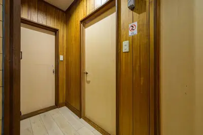 an empty hallway with two doors in a building at \u4e94\u53cd\u91ce in Tokyo