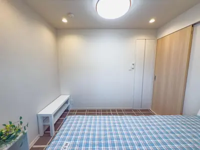 a room with a bed and a bench in it at \u7530\u753a6Floor-MT0393 in Tokyo