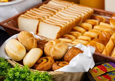 a basket of bread and pastries on a table at APA Hotel Shinagawa Sengakuji Ekimae in Tokyo