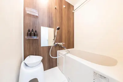 a white bathroom with a sink and a toilet at Forest Side Yoyogi Park 202 in Tokyo