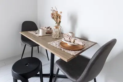 a dining room table with chairs and a wooden plate at Forest Side Yoyogi Park 202 in Tokyo
