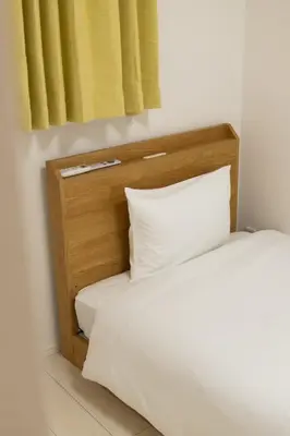 a bed with a wooden headboard and a pillow at japan house sumida House I Cozy&stylish in Tokyo
