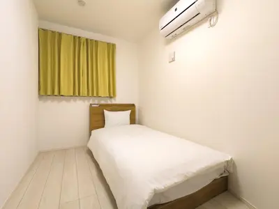 a small bedroom with a white bed and a window at japan house sumida House I Cozy&stylish in Tokyo