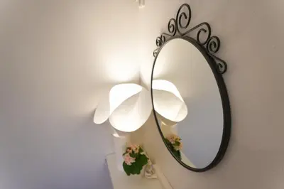 a mirror hanging on a wall with a lamp at Tomo House Yotsuya-Sanchome 301 - from 6 minutes station \u56db\u8c37\u4e09\u4e01\u76ee 301 \u99c5\u304b\u3089\u5f92\u6b696\u5206 in Tokyo