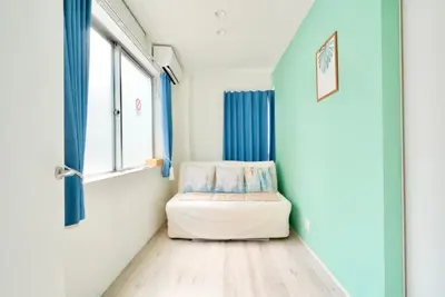 a small room with a bed and a window at Tomo House Oshiage - from 2 minutes station \u62bc\u4e0a \u99c5\u304b\u3089\u5f92\u6b692\u5206 in Tokyo